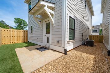A townhouse with wooden fenced-in backyard.
